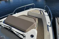 2020 Nimbus T8 boat with cushioned seating, docked on calm water.