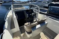 2020 Nimbus T8 boat interior with steering wheel, dashboard, and seating, docked at marina.