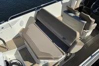 2020 Nimbus T8 boat interior with beige seating and wooden flooring.