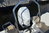 2020 Nimbus T8 boat with Mercury outboard motor, docked on wooden pier.