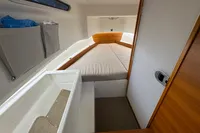 2020 Nimbus T8 cabin interior with bed, storage, and wooden accents.