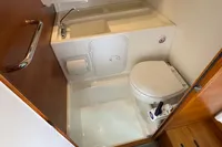 Compact bathroom in 2020 Nimbus T8 boat with toilet, sink, and storage.