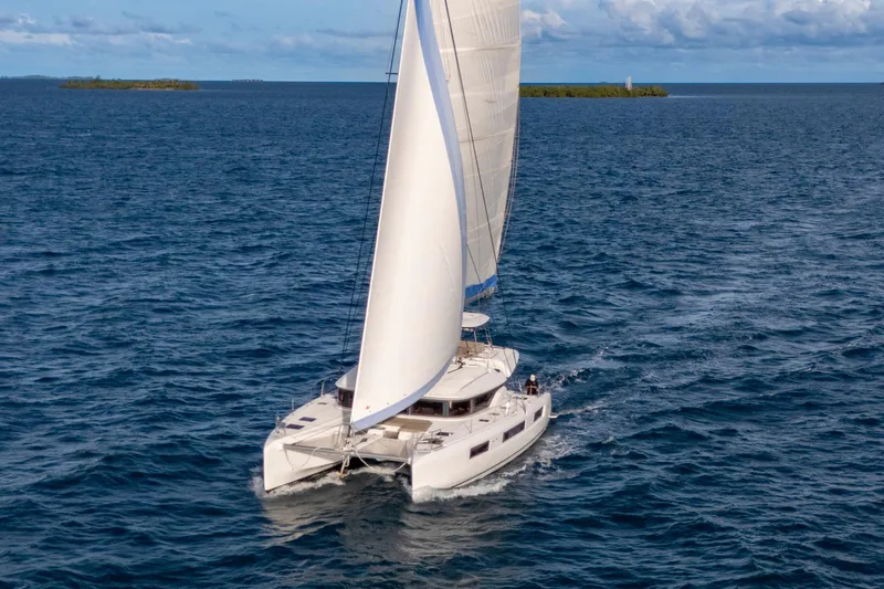 Bellissima Yacht Photos Pics 2024 Lagoon 51 catamaran sailing on open sea with full sails.