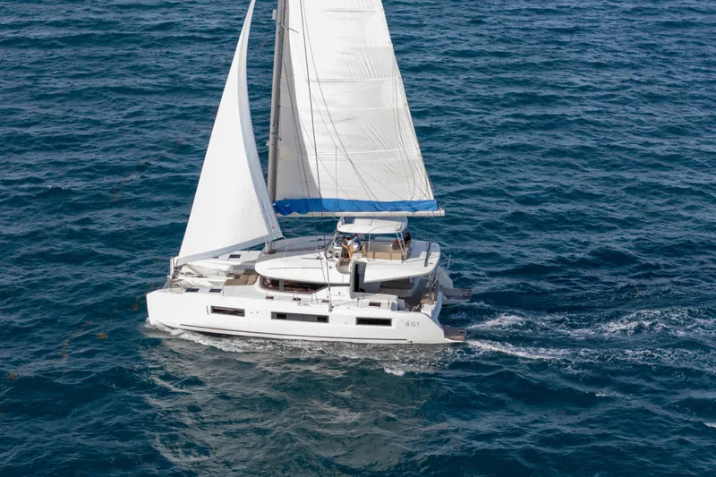 Bellissima Yacht Photos Pics 2024 Lagoon 51 sailing catamaran cruising on open sea with full sails.