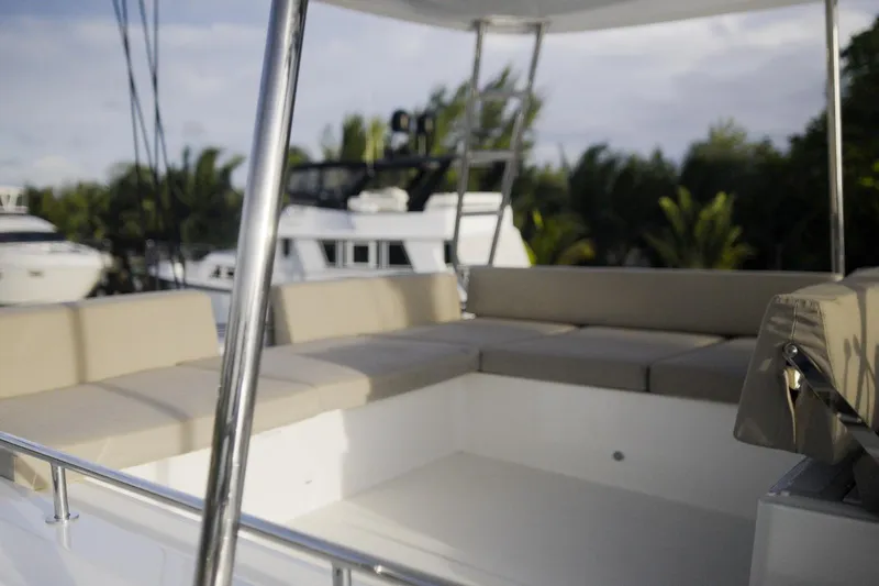 Bellissima Yacht Photos Pics Luxurious seating area on 2024 Lagoon 51 yacht, surrounded by lush greenery.