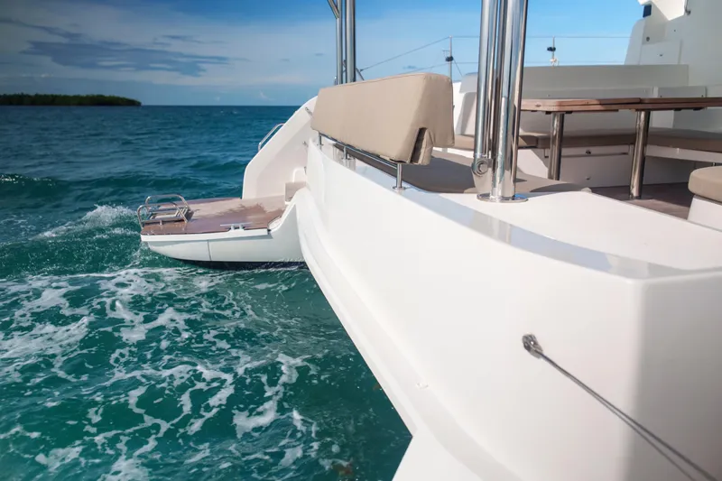 Bellissima Yacht Photos Pics 2024 Lagoon 51 catamaran on turquoise sea, featuring spacious deck and seating area.