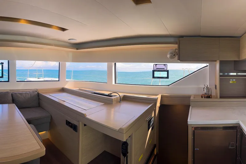 Bellissima Yacht Photos Pics Luxurious interior of 2024 Lagoon 51 yacht with ocean view through large windows.