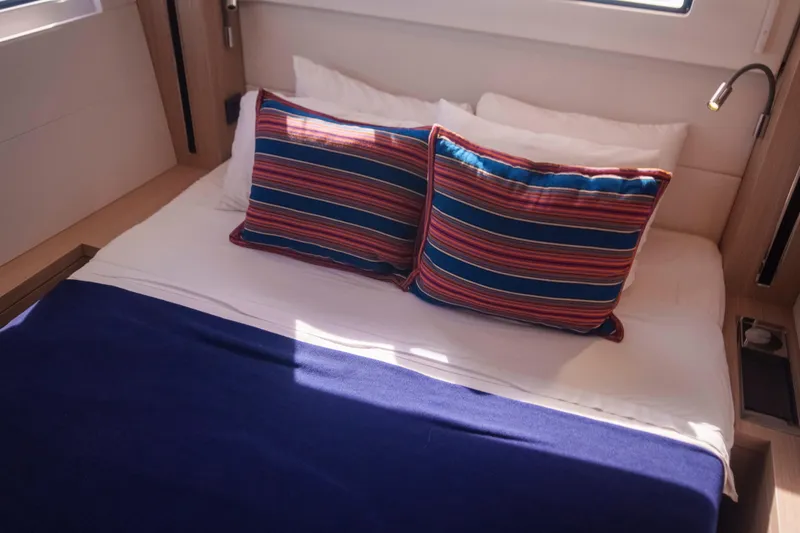 Bellissima Yacht Photos Pics Cozy cabin bed with striped pillows in 2024 Lagoon 51 yacht.