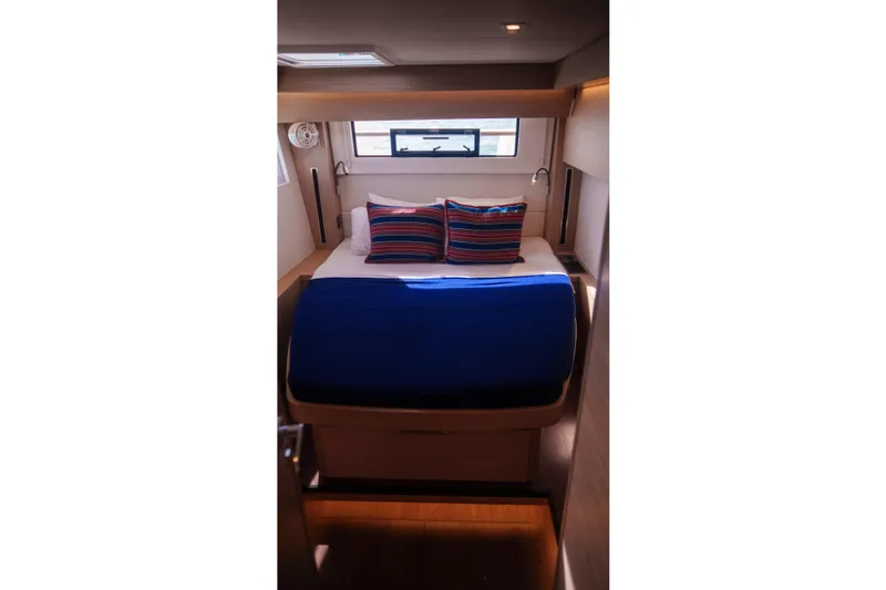 Bellissima Yacht Photos Pics Luxurious cabin interior of 2024 Lagoon 51 yacht with cozy bedding.
