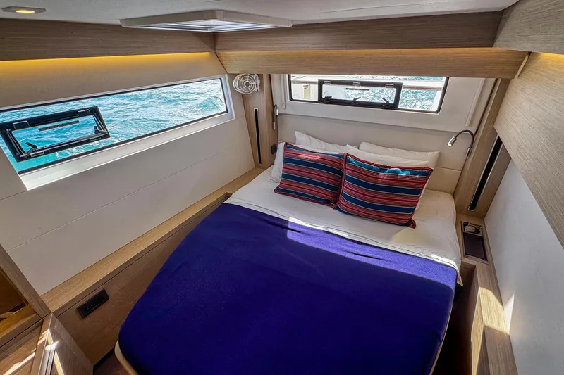 Bellissima Yacht Photos Pics Luxurious cabin interior of 2024 Lagoon 51 yacht with ocean view.