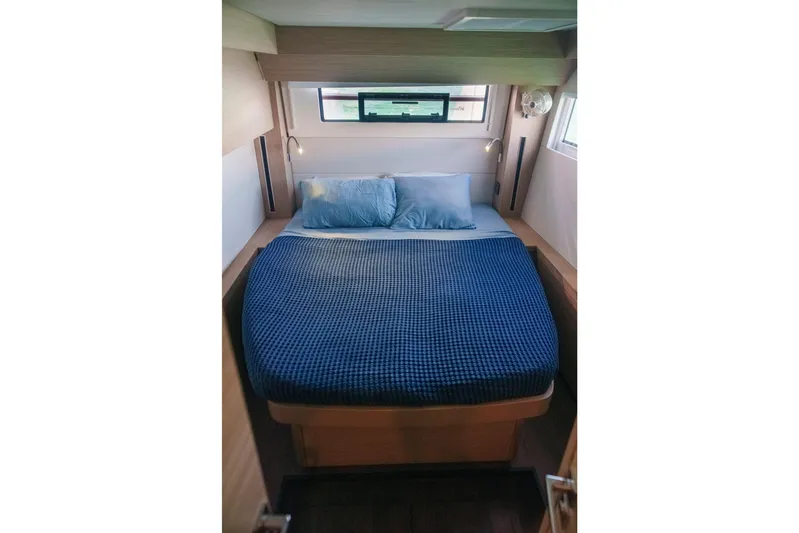 Bellissima Yacht Photos Pics 2024 Lagoon 51 yacht bedroom with blue bedding and modern design.