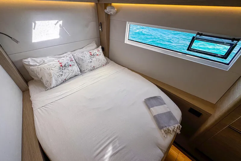 Bellissima Yacht Photos Pics Luxurious cabin interior of 2024 Lagoon 51 yacht with ocean view window.