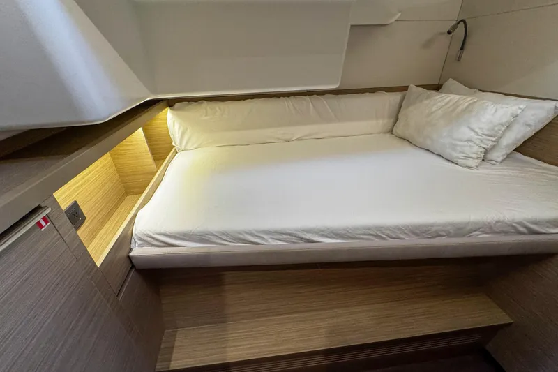 Bellissima Yacht Photos Pics 2024 Lagoon 51 yacht interior cabin with cozy bed and ambient lighting.