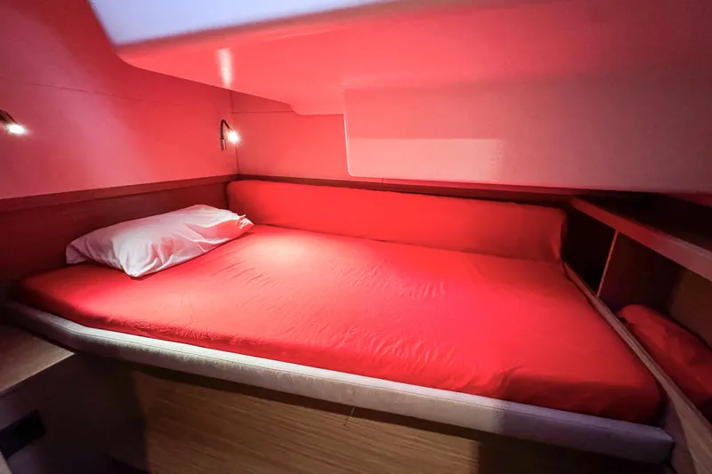 Bellissima Yacht Photos Pics Cozy cabin interior with red bedding in 2024 Lagoon 51 yacht.