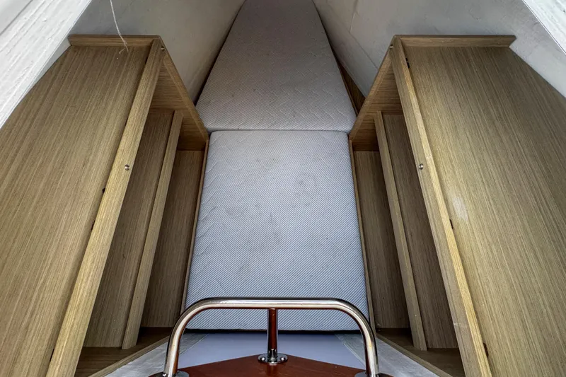 Bellissima Yacht Photos Pics Interior cabin of 2024 Lagoon 51 yacht with wooden storage and mattress.