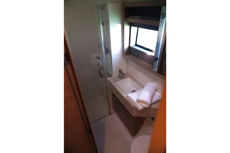 Bellissima Yacht Photos Pics Bathroom interior of 2024 Lagoon 51 yacht with modern sink and shower.