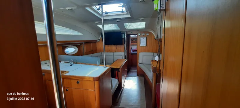  Yacht Photos Pics Interior of 2007 Elan Impression 434 yacht with wooden furnishings and seating area.