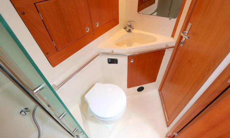  Yacht Photos Pics 2007 Elan Impression 434 yacht bathroom with wooden cabinets and compact fixtures.