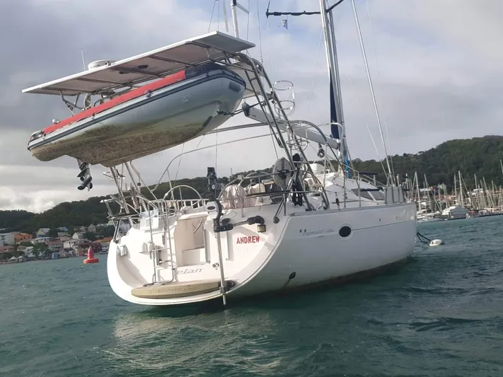  Yacht Photos Pics Sailboat Elan Impression 434 (2007) with dinghy, anchored in a scenic harbor.