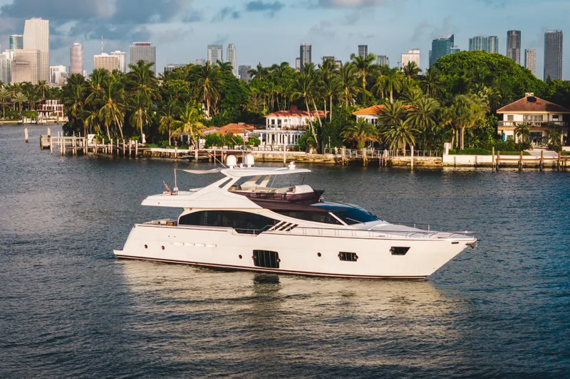 Lady Nelly Yacht Photos Pics Luxurious 2014 Ferretti Yachts 870 cruising near a tropical shoreline with city skyline.