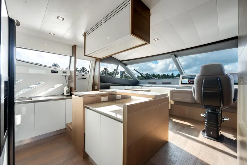 Lady Nelly Yacht Photos Pics Luxurious interior of 2014 Ferretti Yachts 870 with modern helm and kitchen area.