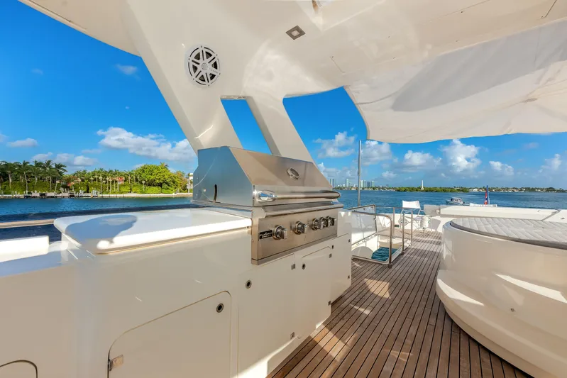 Lady Nelly Yacht Photos Pics Luxurious 2014 Ferretti Yachts 870 deck with grill, overlooking serene waterfront views.