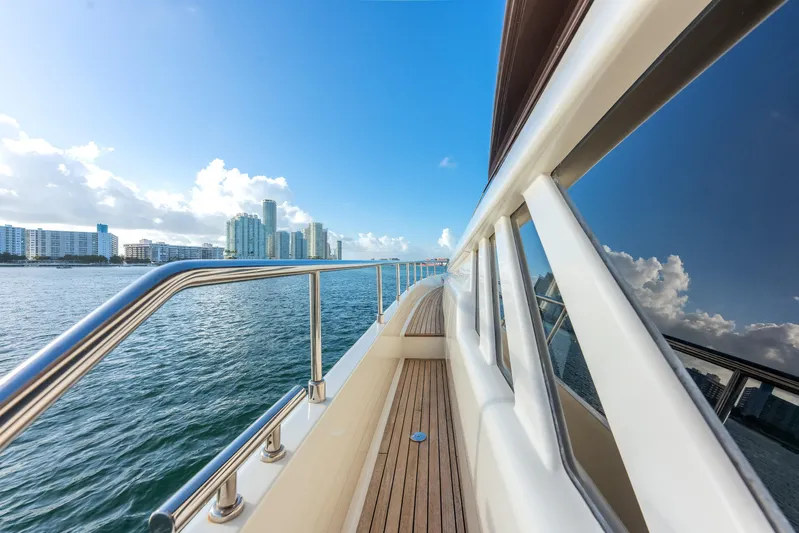 Lady Nelly Yacht Photos Pics Side view of 2014 Ferretti Yachts 870 cruising near city skyline.