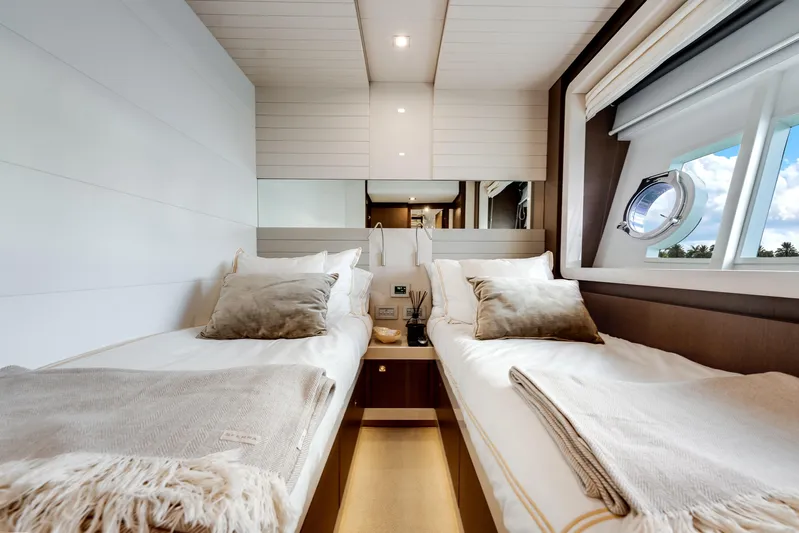 Lady Nelly Yacht Photos Pics Luxurious twin cabin interior on a 2014 Ferretti Yachts 870, featuring elegant bedding and a scenic window view.