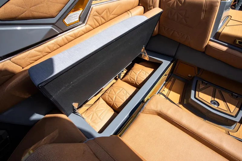  Yacht Photos Pics 2024 Nautique Super Air Nautique G23 Paragon interior with open storage compartment.