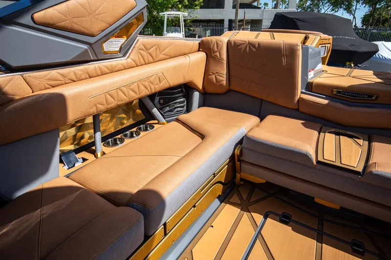  Yacht Photos Pics Luxurious interior of 2024 Nautique Super Air Nautique G23 Paragon boat with tan upholstery.