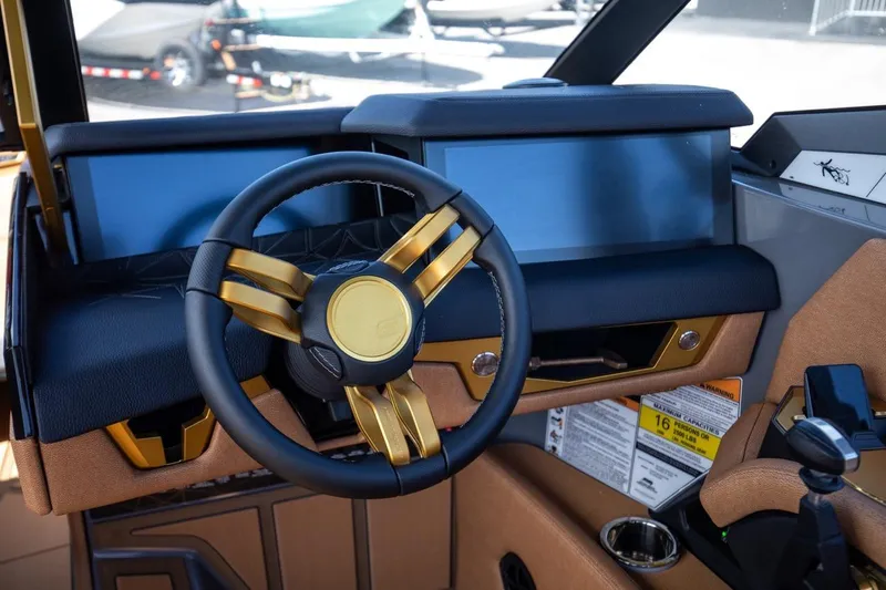  Yacht Photos Pics 2024 Nautique Super Air Nautique G23 Paragon dashboard with sleek steering wheel design.