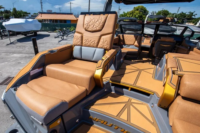  Yacht Photos Pics 2024 Nautique Super Air Nautique G23 Paragon interior with luxurious tan seating and modern design.