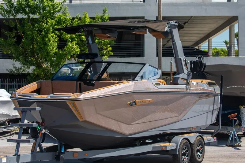  Yacht Photos Pics 2024 Nautique Super Air Nautique G23 Paragon boat on trailer, sleek design, outdoor setting.
