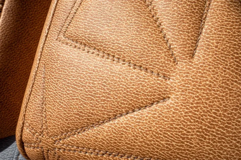  Yacht Photos Pics Close-up of tan leather upholstery with detailed stitching, 2024 Nautique Super Air Nautique G23 Paragon.