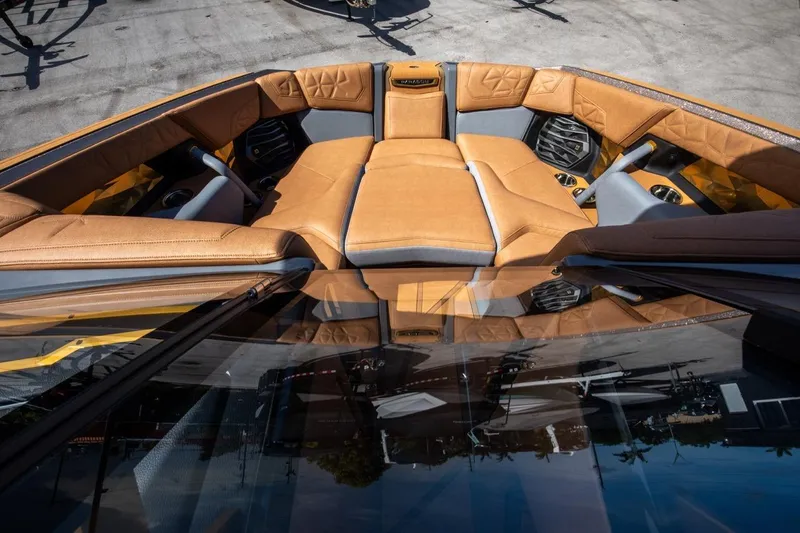  Yacht Photos Pics 2024 Nautique Super Air Nautique G23 Paragon interior with luxurious tan seating and cup holders.