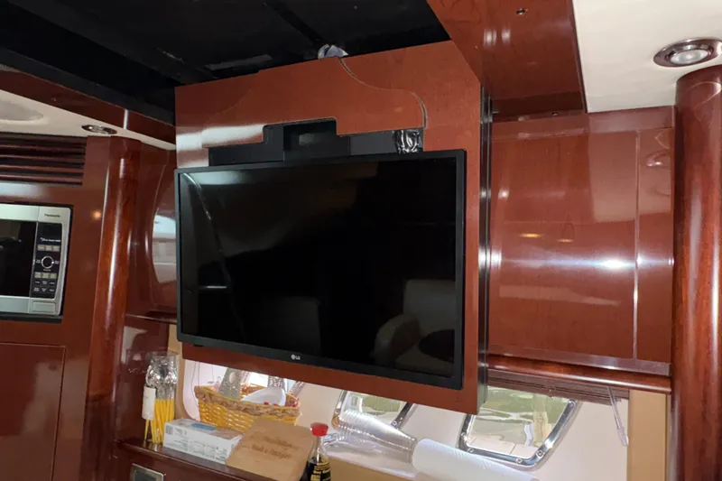  Yacht Photos Pics Interior of 2008 Sea Ray 40 Sundancer with mounted LG TV and wooden cabinetry.