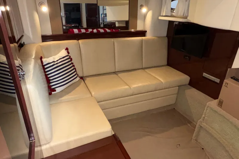  Yacht Photos Pics Interior of 2008 Sea Ray 40 Sundancer yacht with beige seating and striped pillow.