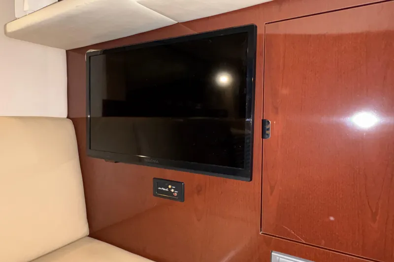  Yacht Photos Pics Flat-screen TV in 2008 Sea Ray 40 Sundancer yacht interior with wood paneling.