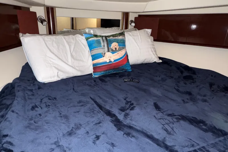  Yacht Photos Pics Cozy cabin bed in 2008 Sea Ray 40 Sundancer with decorative pillow and navy blanket.