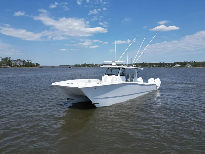  Yacht Photos Pics 2024 Freeman 43 boat on calm water under a clear blue sky.