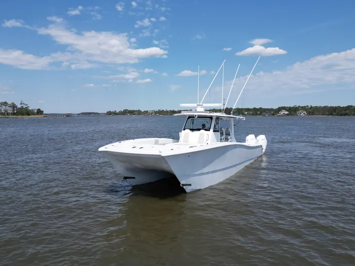  Yacht Photos Pics 2024 Freeman 43 boat on calm water under a clear blue sky.