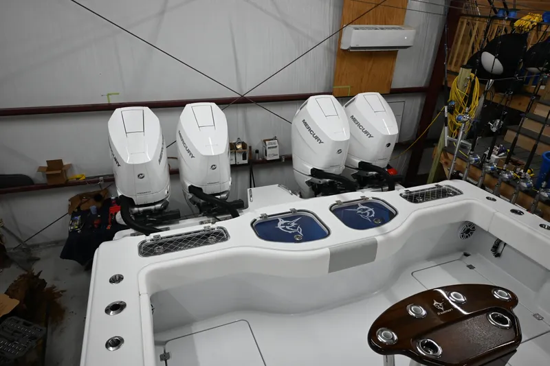  Yacht Photos Pics 2024 Freeman 43 boat with four powerful outboard engines in a spacious indoor setting.