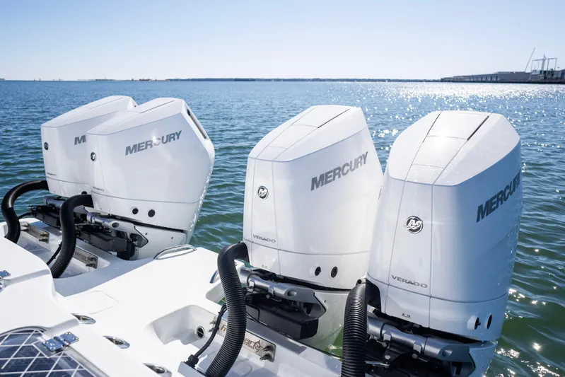  Yacht Photos Pics Four Mercury Verado outboard engines on a 2024 Freeman 43 boat, glistening on open water.