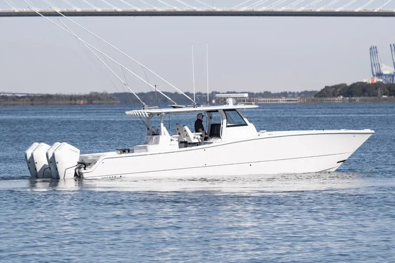  Yacht Photos Pics 2024 Freeman 43 boat cruising on water with dual outboard engines.