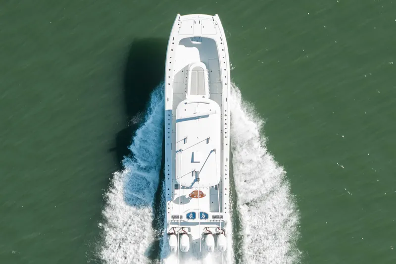  Yacht Photos Pics Aerial view of 2024 Freeman 43 boat cruising on green water.