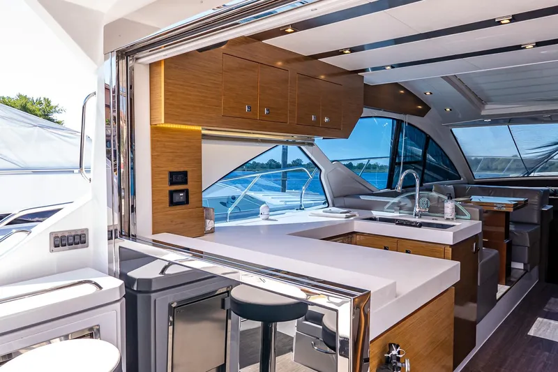 My Way Yacht Photos Pics Luxurious interior of 2019 Cruisers Yachts 54 Cantius with modern kitchen and seating area.