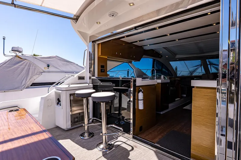 My Way Yacht Photos Pics Luxurious 2019 Cruisers Yachts 54 Cantius interior with modern bar and seating area.