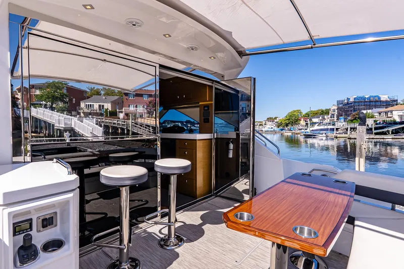 My Way Yacht Photos Pics Luxurious 2019 Cruisers Yachts 54 Cantius interior with bar stools and waterfront view.