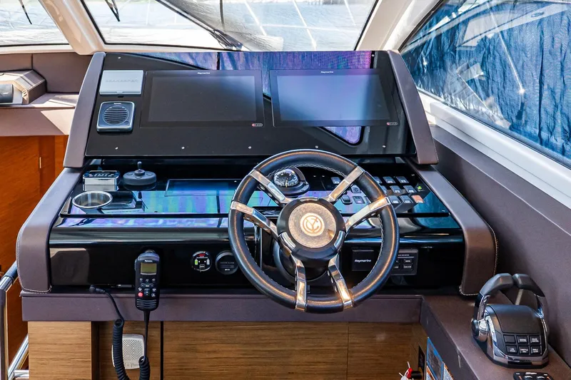 My Way Yacht Photos Pics 2019 Cruisers Yachts 54 Cantius helm with modern navigation controls and steering wheel.
