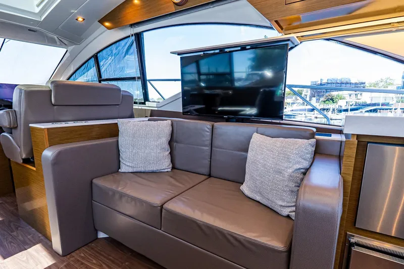 My Way Yacht Photos Pics Luxurious interior of 2019 Cruisers Yachts 54 Cantius with leather seating and large windows.